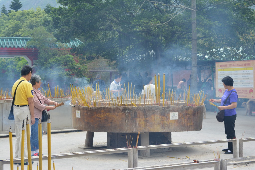 Burning the long sticks of incense.